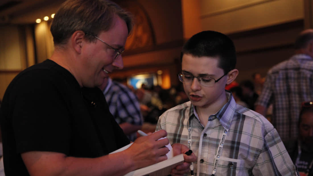 Linus Torvalds signing a book for Zachary DuPont